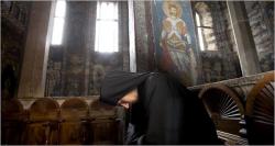a-monk-prays-in-the-decani-orthodox-monastery - a-monk-prays-in-the-decani-orthodox-monastery.jpg